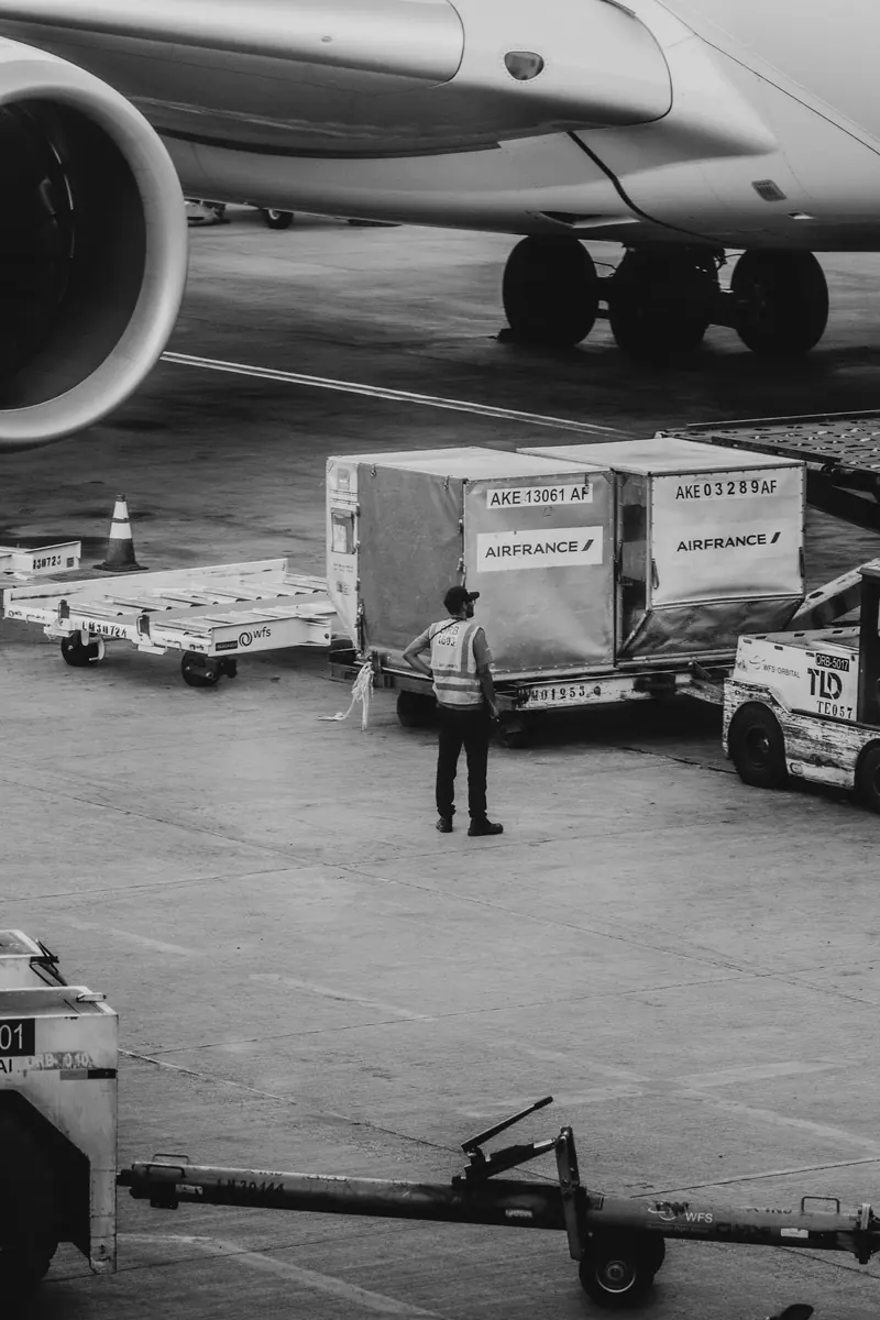 Air cargo containers loaded beside an aircraft